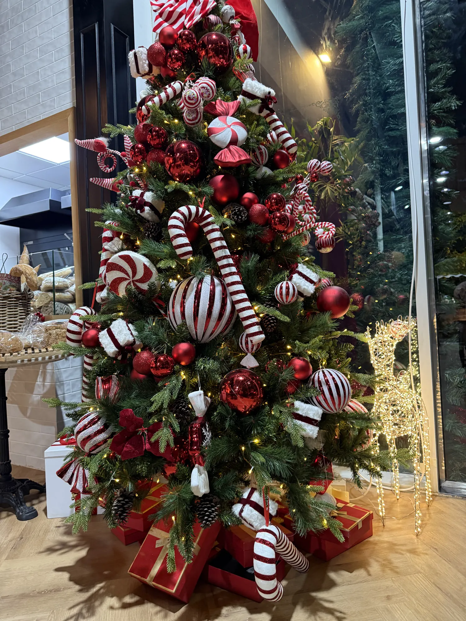 A playful tree decorated with red and white candy canes and sweets